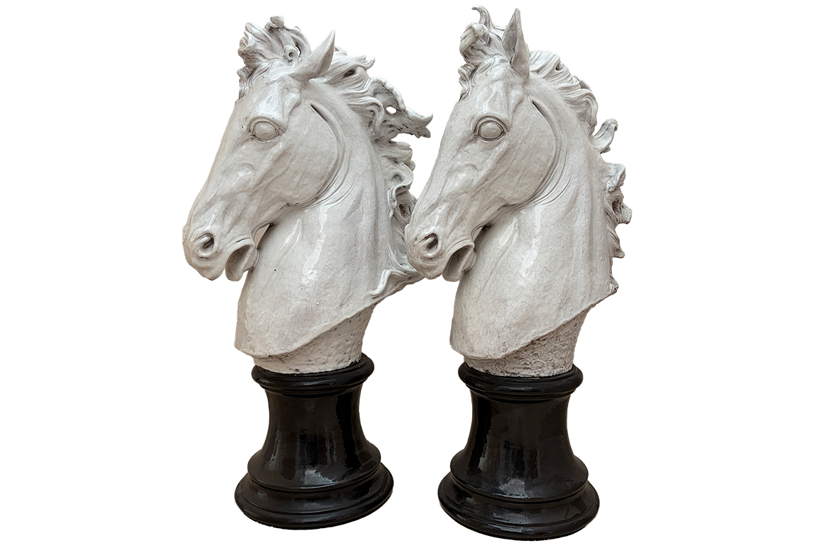 1 COPPIA DI SCULTURE IN CERAMICA COLORE BIANCO RAFFIGURANTE TESTA DI CAVALLO, BASAMENTO CILINDRICO COLORE NERO DIM. 54x96x33 CM